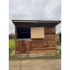 12x12 with top/bottom stable doors, wooden skids & an overhang