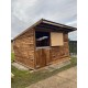 12x12 with top/bottom stable doors, wooden skids & an overhang